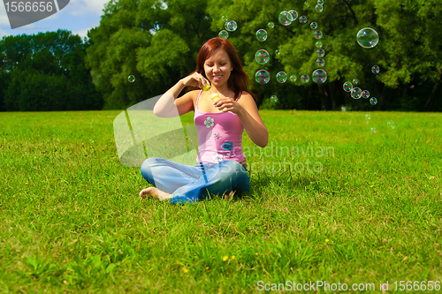 Image of girl blowing soap bubbles