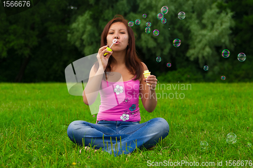 Image of girl blowing soap bubbles