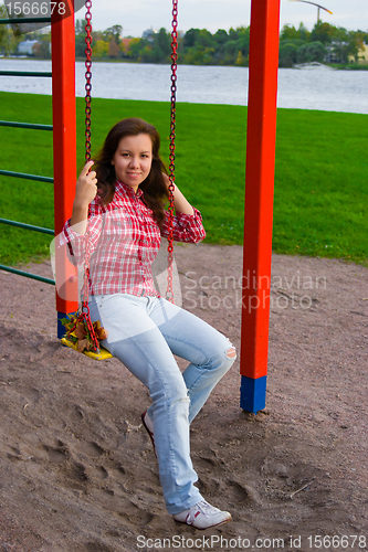 Image of happy young woman on playground