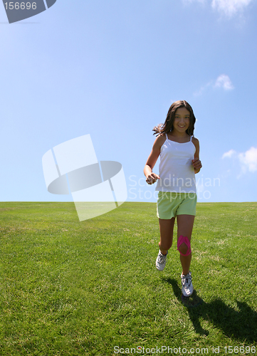 Image of Girl running on grass