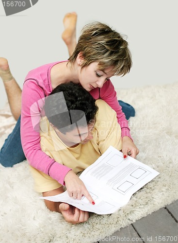 Image of Sweet young couple reading instruction manual
