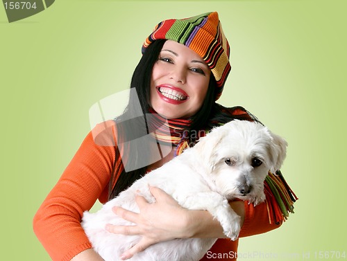 Image of Woman holding a dog in her arms