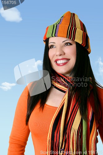 Image of Cheerful woman in winter scarf and hat