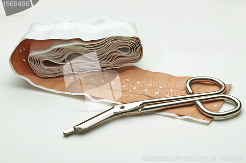 Image of scissors and adhesive plaster