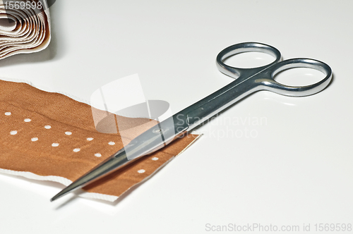 Image of scissors and band-aid