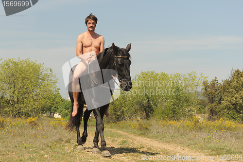 Image of naked man and stallion