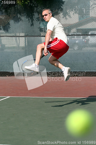 Image of Middleage man playing tennis