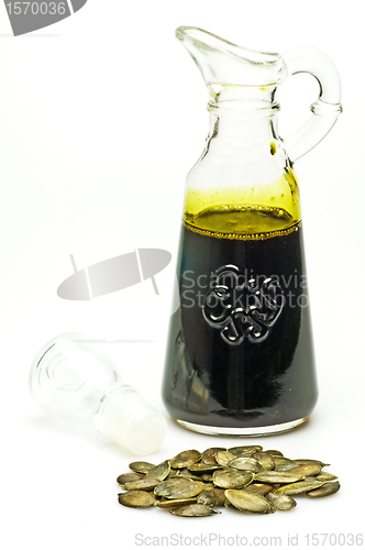 Image of pumpkin seed oil with seeds