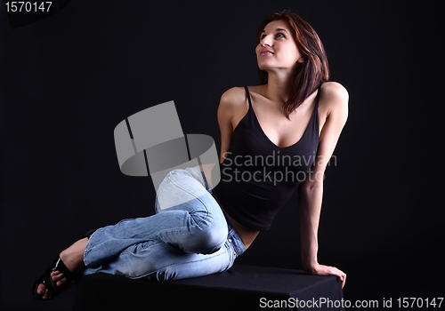 Image of Girl lies at dark background