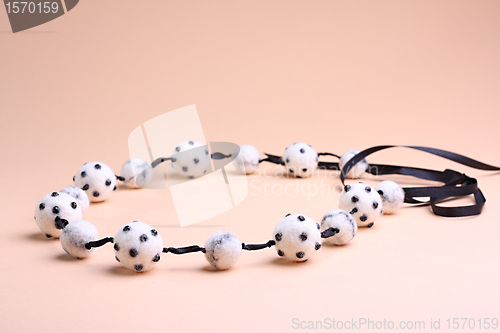 Image of White beads at pink background