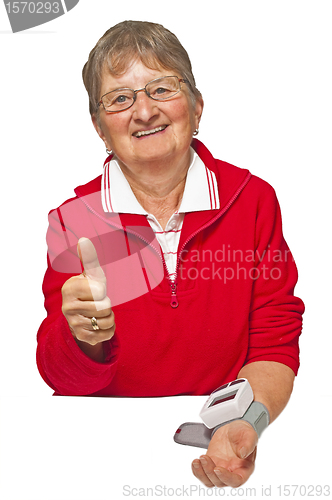 Image of pensioner is measuring her blood pressure