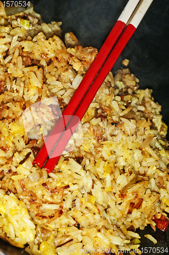 Image of baked rice with chopsticks