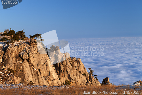 Image of Mountains at sunset and sea in clouds