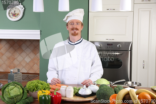 Image of Young chef preparing lunch in kitchen