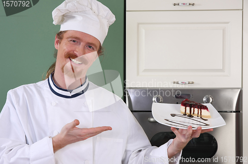 Image of Young chef with piece of cake