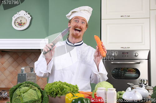 Image of Funny young chef preparing lunch in kitchen
