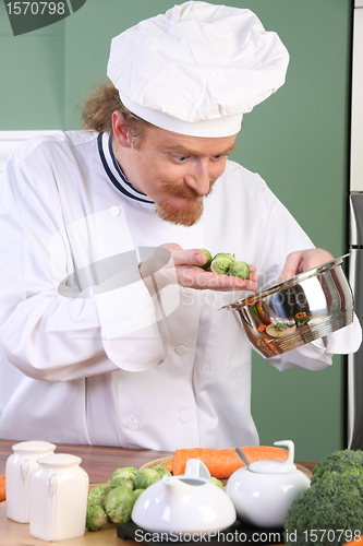 Image of Funny young Chef with Brussels sprouts