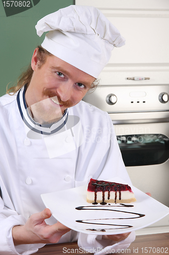 Image of Young chef with piece of cake