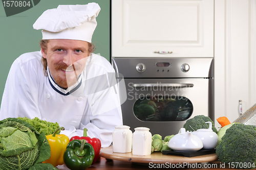 Image of Young chef preparing lunch in kitchen