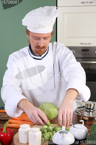 Image of Young chef preparing lunch in kitchen