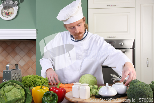 Image of Young chef preparing lunch in kitchen