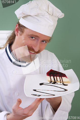 Image of Young chef with piece of cake