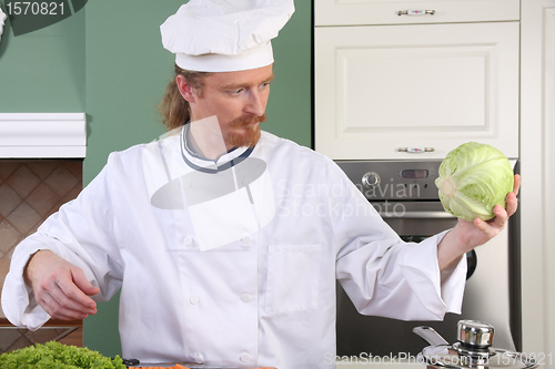 Image of Young chef preparing lunch in kitchen