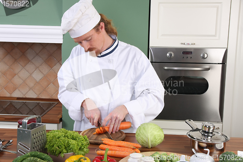 Image of Young chef preparing lunch in kitchen