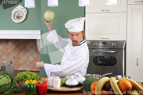 Image of Young chef preparing lunch in kitchen