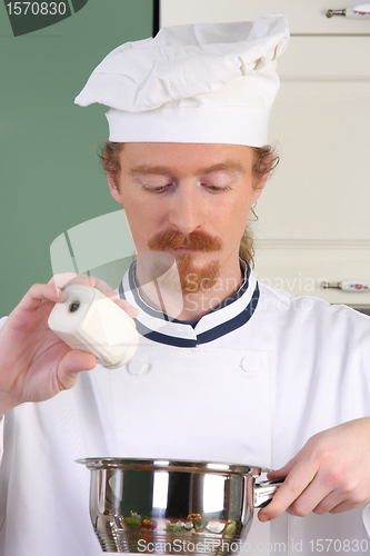 Image of Young chef preparing lunch in kitchen