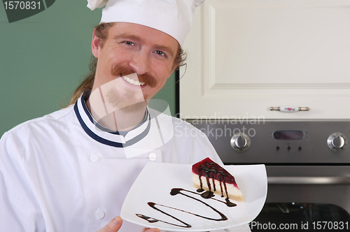 Image of Young chef with piece of cake