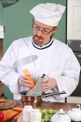 Image of Young chef preparing lunch in kitchen