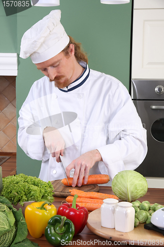 Image of Young chef preparing lunch in kitchen