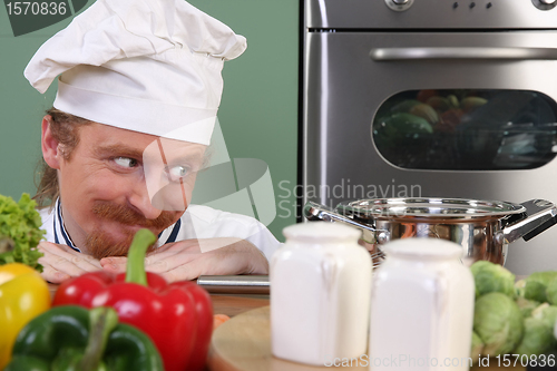 Image of Young chef preparing lunch in kitchen 