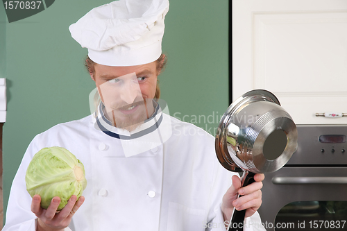 Image of Young chef preparing lunch in kitchen