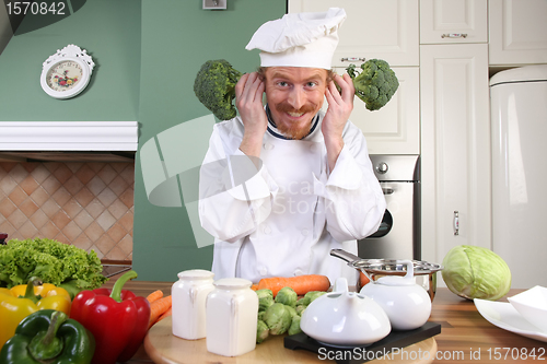 Image of Funny young Chef with broccoli