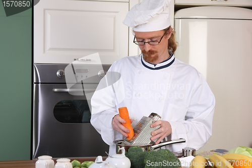 Image of Young chef preparing lunch in kitchen