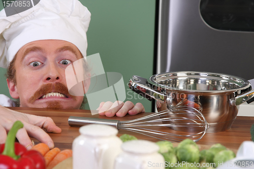 Image of Funny young chef with a pot