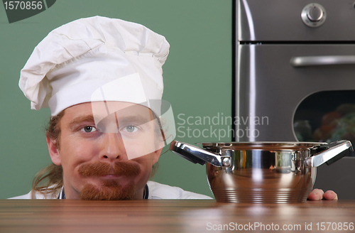 Image of Funny young chef with a pot