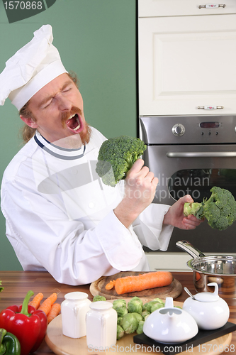 Image of Funny young Chef with broccoli