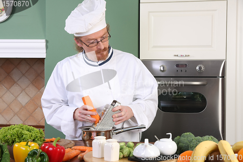 Image of Young chef preparing lunch in kitchen