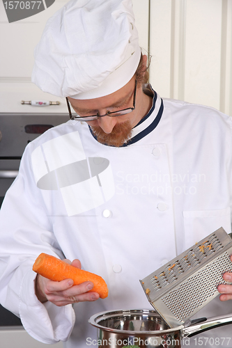 Image of Young chef preparing lunch in kitchen