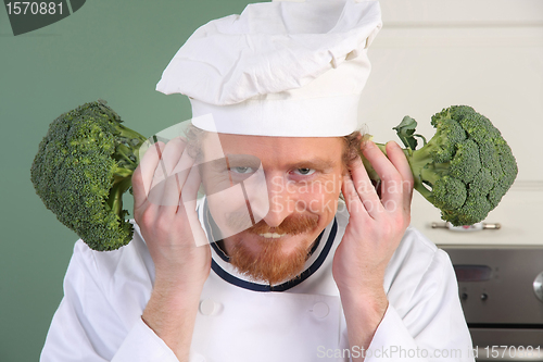 Image of Funny young Chef with broccoli