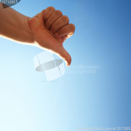Image of thumbs down on a blue background
