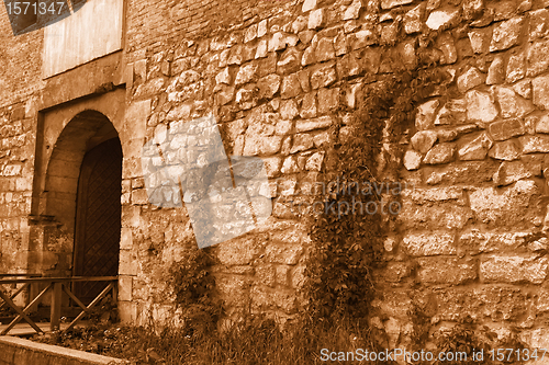 Image of Medieval stone wall with an iron gate