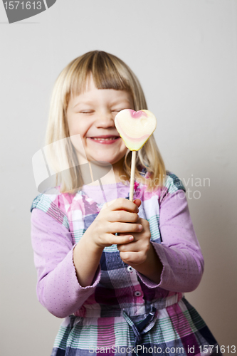 Image of Little girl with lollipop