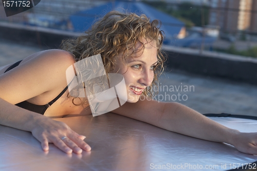Image of Young woman on roof