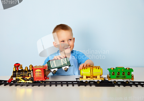 Image of Boy playing with toy railroad