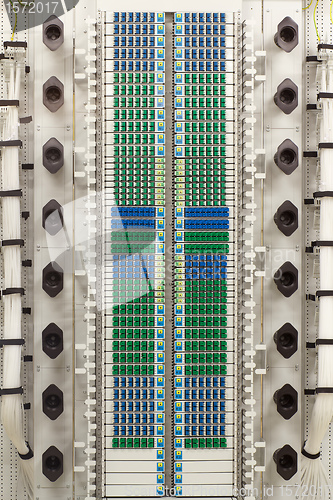 Image of fiber optic rack with high density of blue and green SC connectors