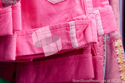 Image of children's trousers on a hanger in the store